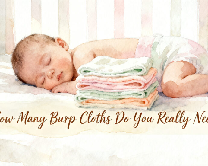 stack of folded burp cloths next to a newborn